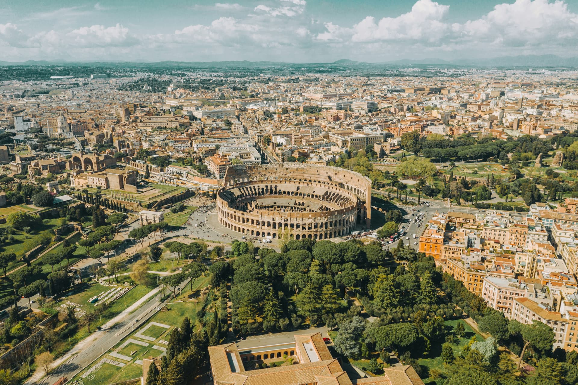 Panoramic view of Rome at sunset with the Colosseum in the distance