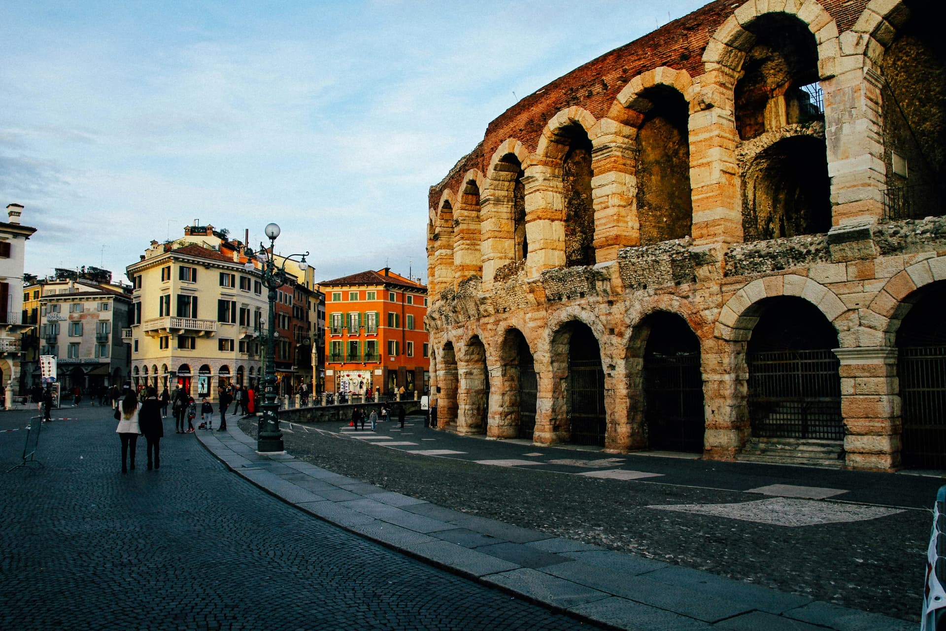 Couple standing near the Colosseum in Rome on a sunny day