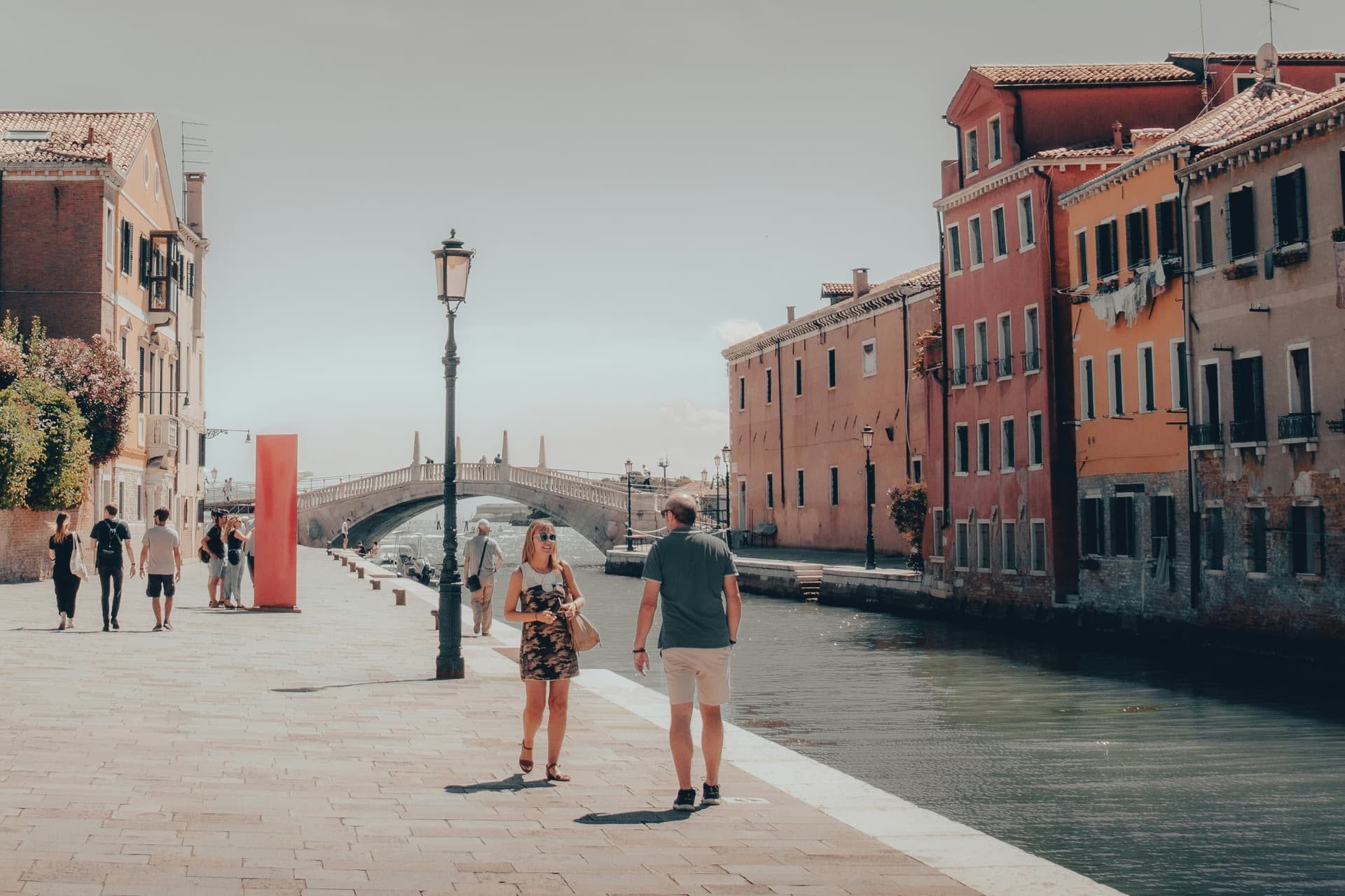 Couple sitting by the Grand Canal in Venice at sunset