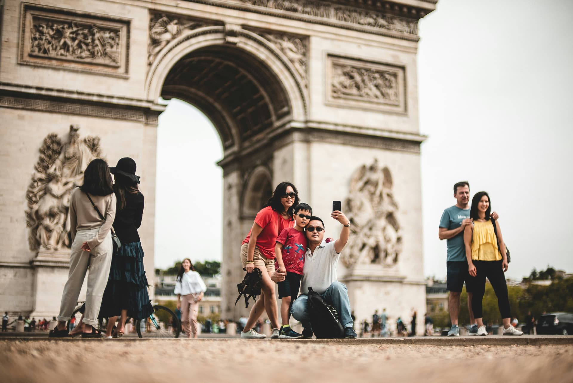 Happy family in Paris with Eiffel Tower in background at sunset
